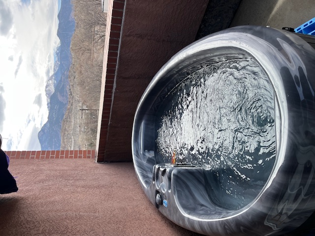 a jacuzzi tub on a balcony with water and bubbles