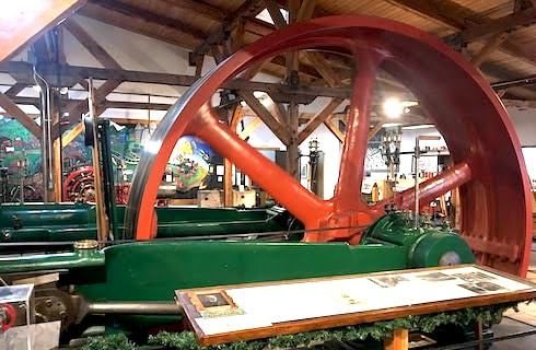 Large orange wheel used for mining for gold years ago