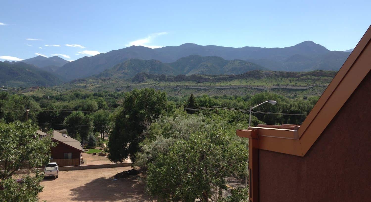 View from the rear of the property of a mountain range covered in green trees