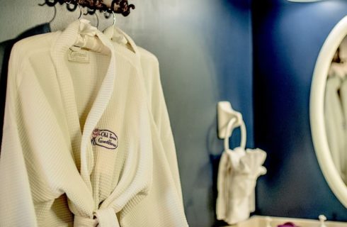 Close up view of white robe with Old Town Guesthouse logo