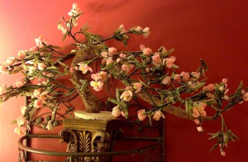 Close up view of a decorative wall hanging of an artistic cherry blossom tree